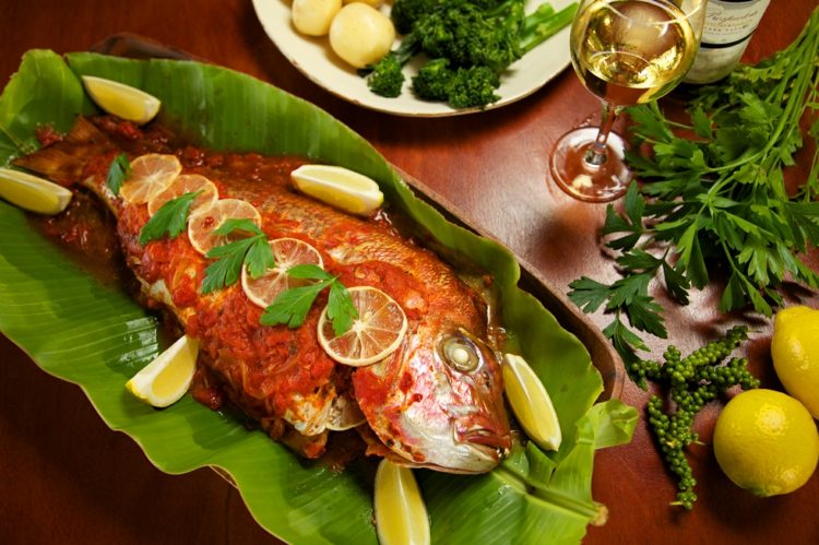 Mad, der kombinerer opskrifter fisk-bagt-tomatsauce-banan-blad-citron-hel-skiver-persille-glas-tallerken-bord