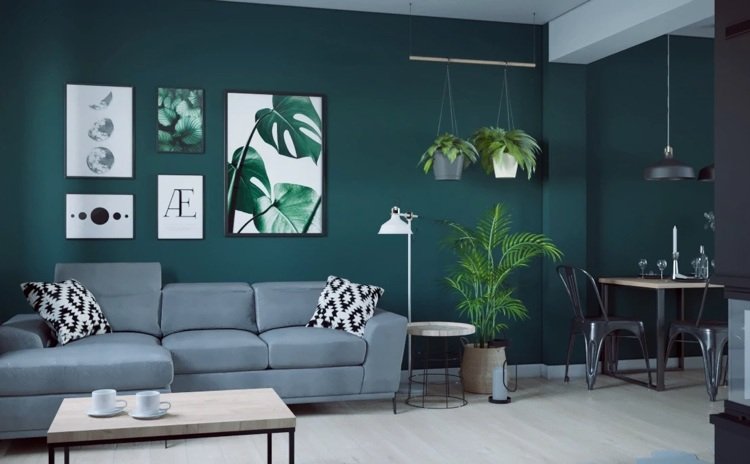 Stil urban dreng i stuen mørkegrøn væg, grå sofa og sorte elementer