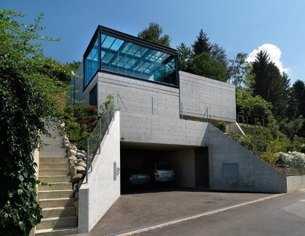 moderne hus på skråningen betonfacade garage glas trapper