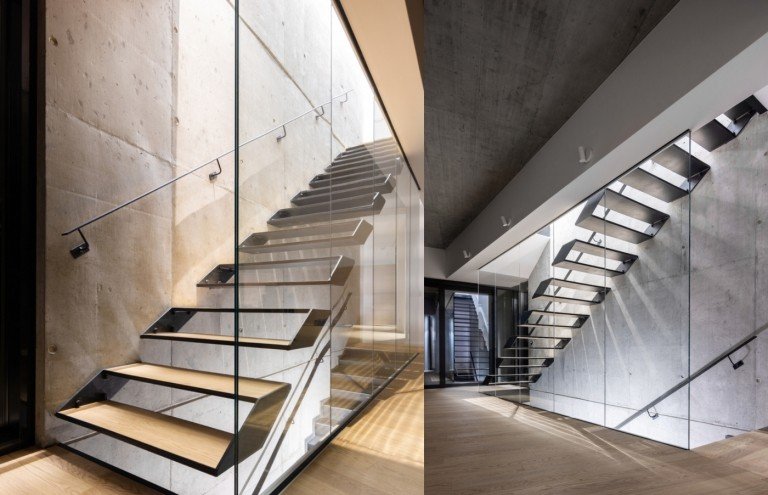 Interiørarkitektur med synlige betonvægge og en trappe i træ- og metalrækværk