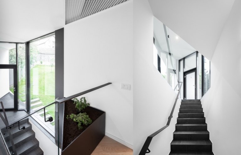 Moderne indretning med trapper med skiferfliser og hvidmalede vægge