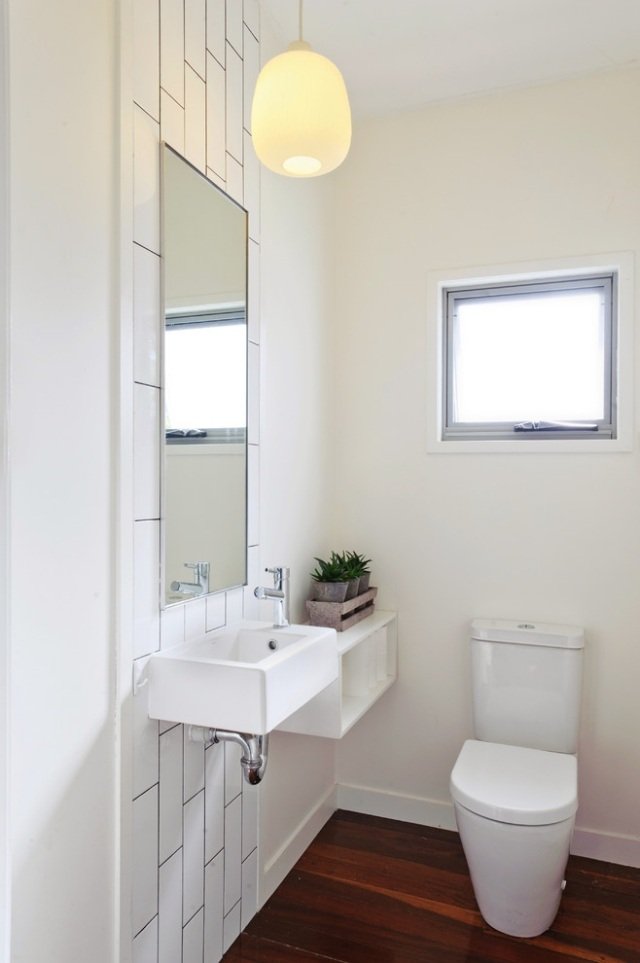 minimalistisk-mini-badeværelse-toilet-håndvask-trægulve-varm-optik