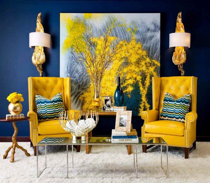 Dve žlté kreslá v obývacej izbe s modrou stenou