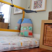 Dekorativ kudde på madrassen i barnrummet