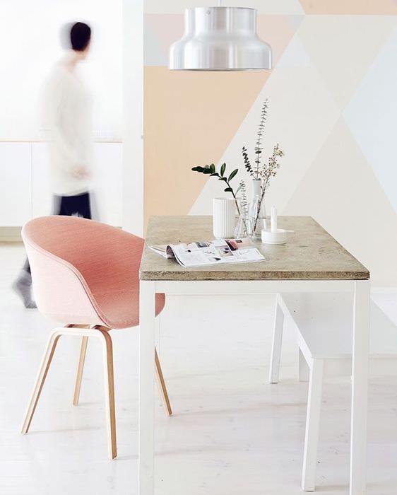 Vaaleanpunainen nojatuoli minimalistisessa olohuoneessa