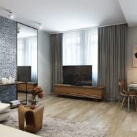 tanken på den vackra designen av vardagsrummet i ett 3-rums lägenhetfoto