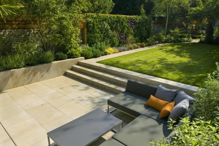 moderne familiehave med grønne havemøbler og terrasse med trin til haven
