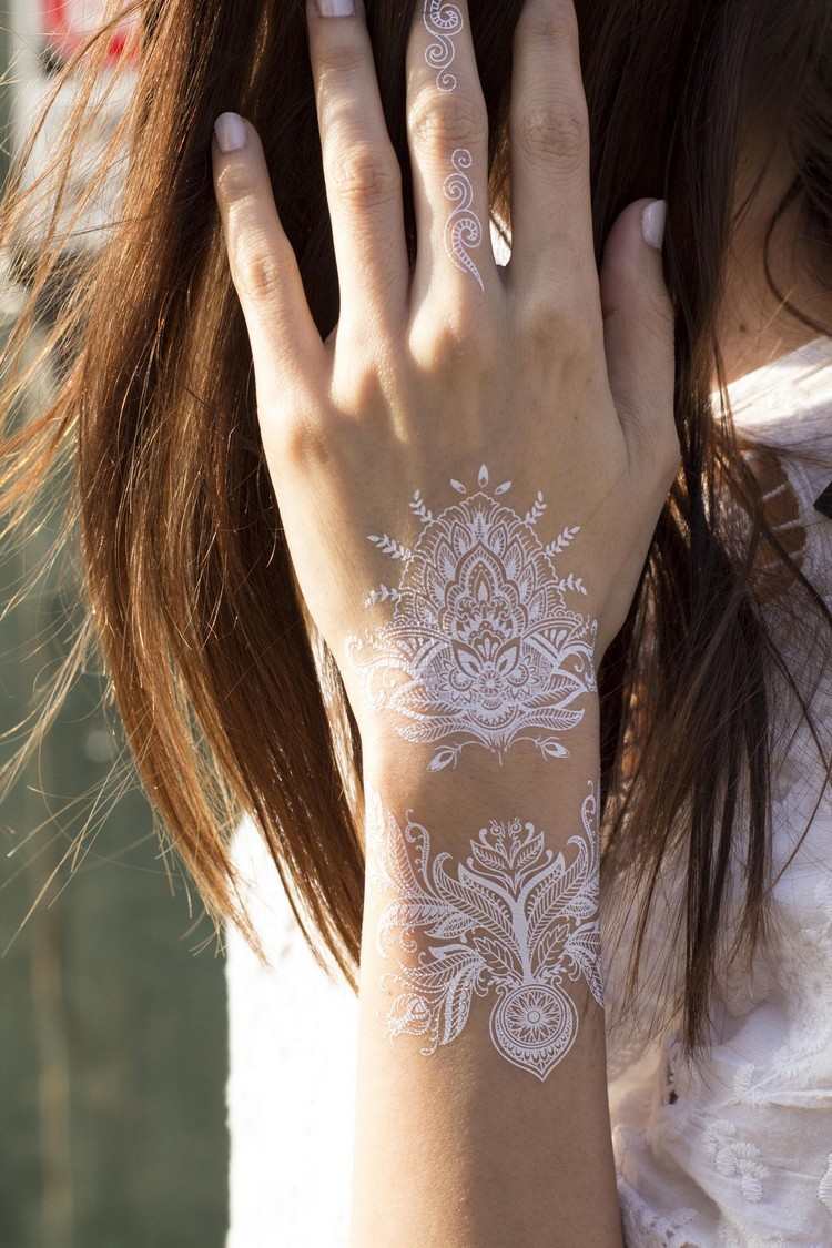 Håndleddetatoveringsdesignkvinder laver selv hvide henna -tatoveringer