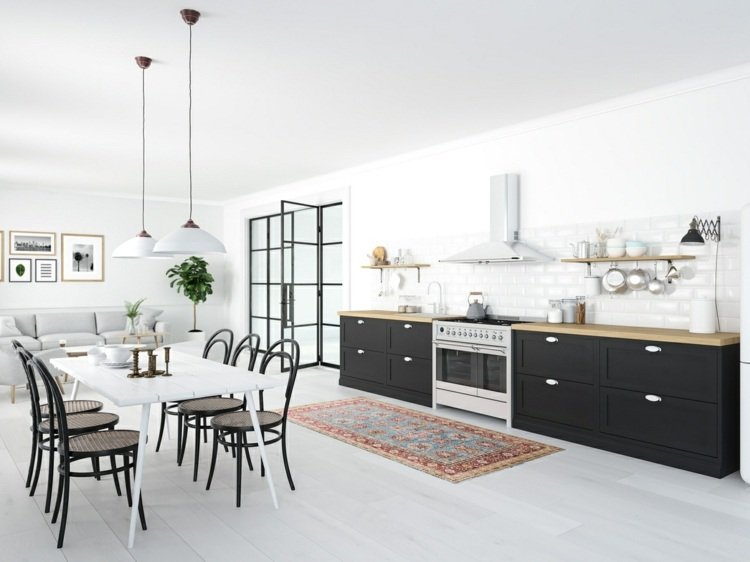 Åbent køkken med opholdsområde og spiseplads i et smalt værelse med moderne møbler